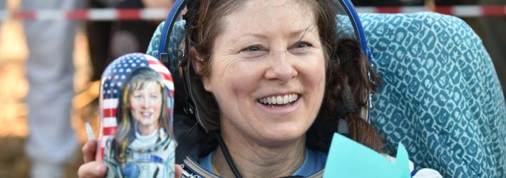 NASA astronaut Tracy C. Dyson is seen smiling and holding a gifted matryoshka doll outside the Soyuz MS-25 spacecraft after she landed with Roscosmos cosmonauts Oleg Kononenko and Nikolai Chub,