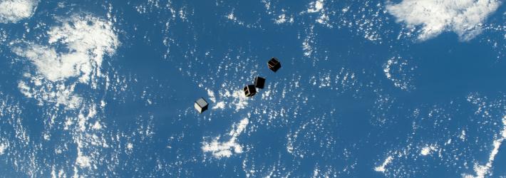 Tiny satellites, also known as CubeSats, are pictured after being deployed into Earth orbit from a small satellite orbital deployer on the outside of the International Space Station's Kibo laboratory module.